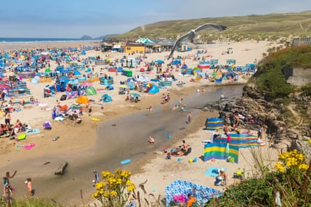 Holiday-makers enjoying hot weather at Perranporth beach in the summer of 2020.