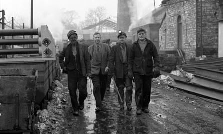 Black and white picture of miners walking towards the camera