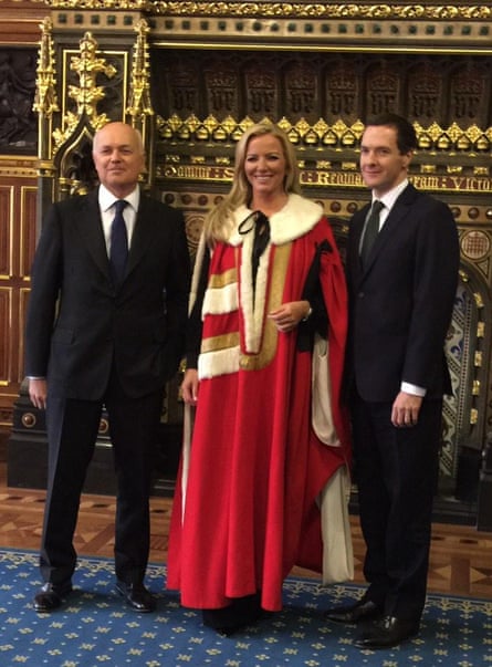 Michelle Mone in ermine robes standing flanked by Iain Duncan Smith and George Osborne, both in dark suits