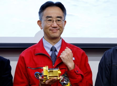 Shinichiro Sakai, project manager of the Slim project, with a miniature model of the probe