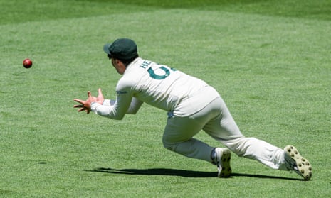 Travis Head swoops to catch Joshua Da Silver on Day 1 of the first Test in Adelaide.