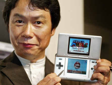 Challenging you to a dual … Miyamoto with the two-screen Nintendo DS in 2004.