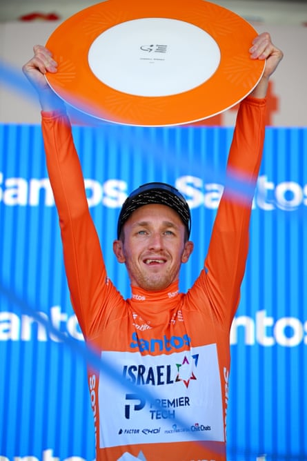 Stephen Williams lifts the Tour Down Under plate in celebration after winning the race