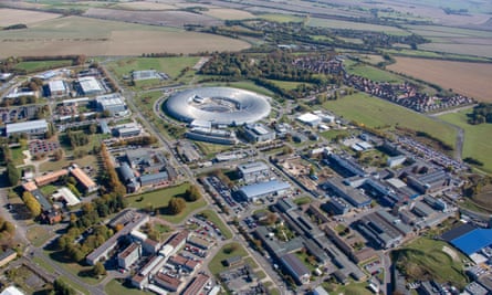 Aerial view of an industrial park in green fields, with some futuristic looking buildings