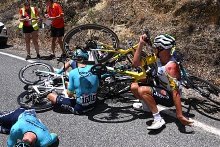 Riders in a pile on the road after crashing