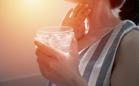 Woman drinking ice water from a cup