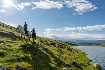 Local herders on horseback along the shore of Lake Hovsgol, Mongolia.