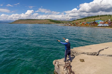 A man fishes off a pier at the Hankh village on the north shore of Lake Hovsgol, Mongolia.