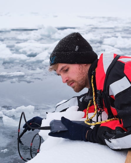 Frederik Bussmann, a marine chemist and PhD student at the Alfred Wegener Institute, measures the salinity at the edge of an ice floe