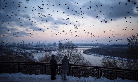 A flock of crows flies over downtown Kyiv.