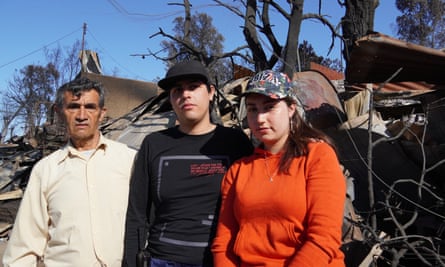 The Hurtado family – father Juan, 75, and siblings Ayenson, 24 and Danitza, 22 – stand where their home used to be before it was destroyed in the blaze in the Achupalla neighbourhood of Viña del Mar.