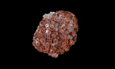 A brown-pink lump of faceted crystal