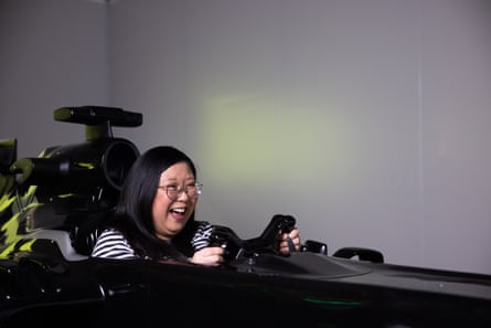 Jennifer Wong looks happy in a F1 replica race car