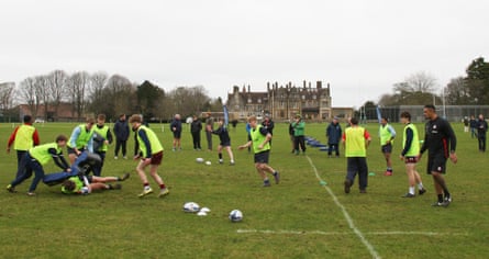 Former All Black Jerome Kaino (right) looks on during a rugby evasion masterclass at Clayesmore school.
