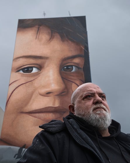 Angelo Di Ponzio in front of a mural of his son Giorgio, who died of cancer at 15, by the Italian street-artist Jorit.