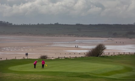 People on the golf course with the sea in the background