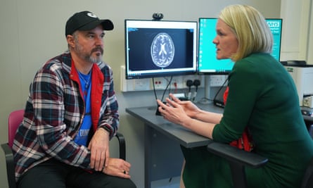 Dr Heather Shaw speaks to Steve Young, with an MRI of his brain on the screen, during a consultation at University College Hospital Macmillan Cancer Centre in London
