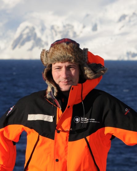 Michael Meredith in warm jacket with water and icebergs in background 