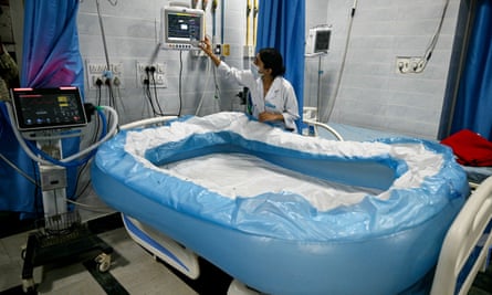 A woman prepares an inflatable bath on a hospital ward