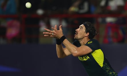 Australia’s Mitchell Starc watches the ball into his hands to catch Scotland’s Michael Leask