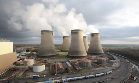 Steam rising from Drax power plant in North Yorkshire with a train in the foreground