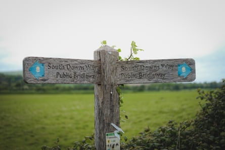 A wooden signpost points to the bridleway on the South Downs Way.