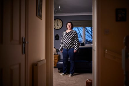 Lucy Keighley, photographed from the hallway while standing in a room in her house 