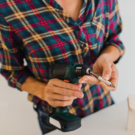 A woman with an electric screwdriver