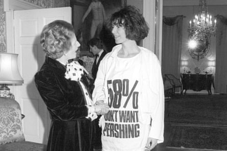 Prime Minister Margaret Thatcher greets fashion designer Katharine Hamnett, wearing at-shirt with a nuclear missile protest message, at 10 Downing Street, where she hosted a reception for British Fashion Week designers.
