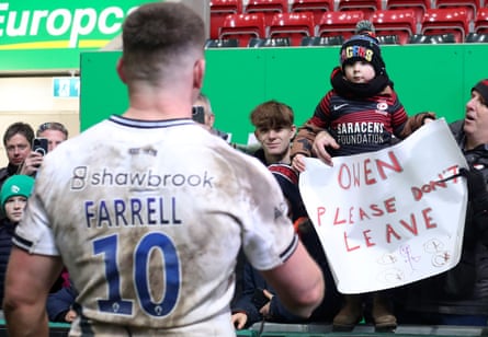 Saracens’ captain Owen Farrell meets a young fan who had made a sign asking him not to leave, after the game against Leicester Tigers in January 2024.