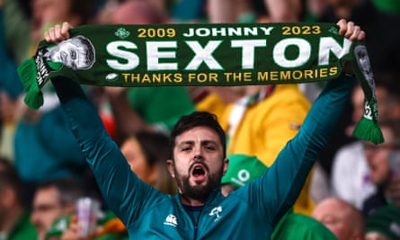 A Ireland supporter holds up a scarf dedicated to Ireland captain Jonathan Sexton during the 2023 Rugby World Cup quarter-final match between Ireland and New Zealand.