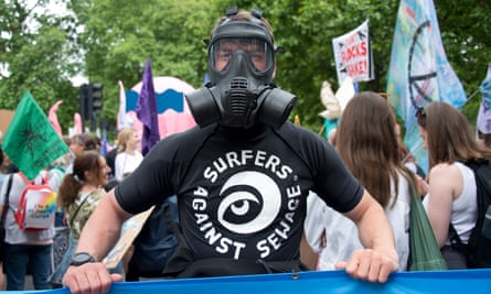Henry Swithinbank in gas mask and t-shirt from Surfers Against Sewage.