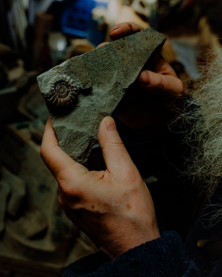 Richard holds one an ammonite in Chris’s workshop.
