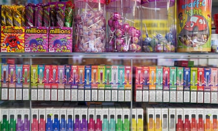 Designed to appeal: colourful packets of disposable vapes on sale below children’s sweets.
